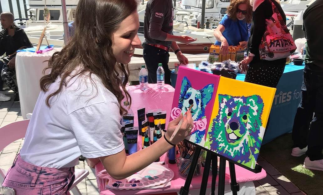 Mars Associate and artist painting dog portraits