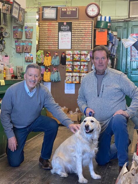 Mattoon Mayor with a local business owner and his dog inside the business, deBuhr's Feed & Seed