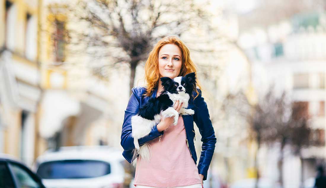 woman with dog in city