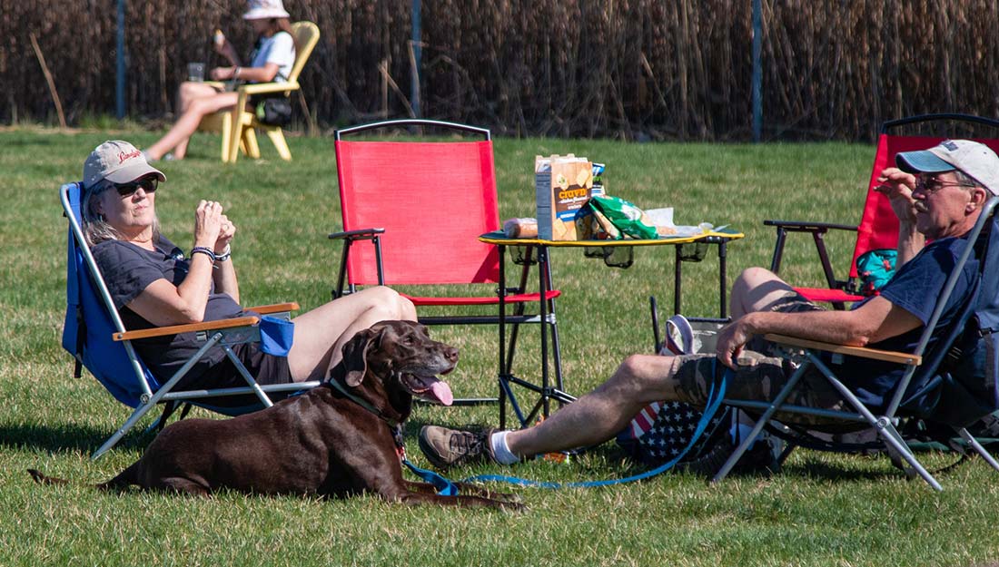 Residents in Sheboygan relax with their dog outside at a local business